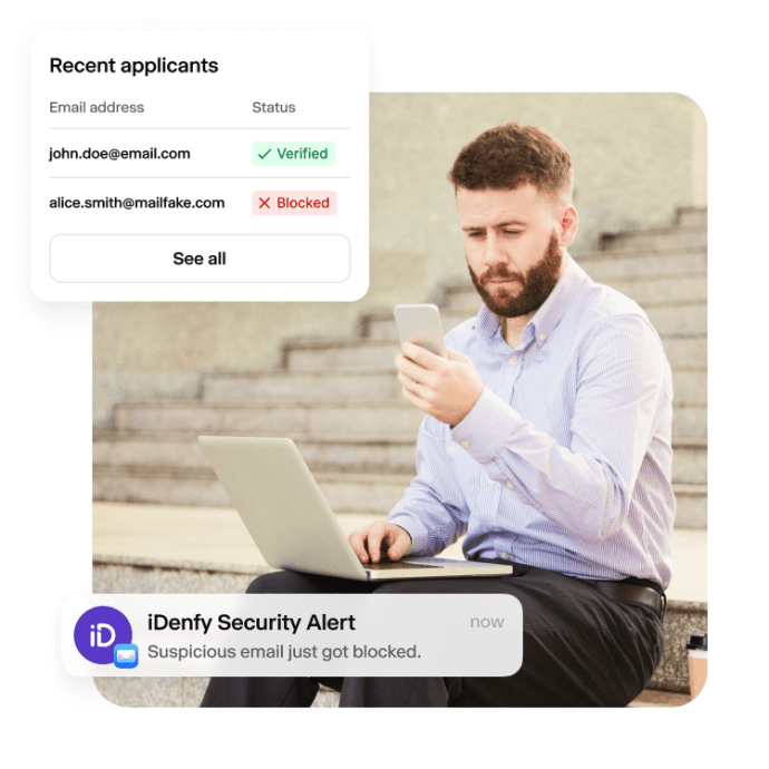 A person is reviewing the iDenfy security alert regarding a blocked user due to an invalid email address.