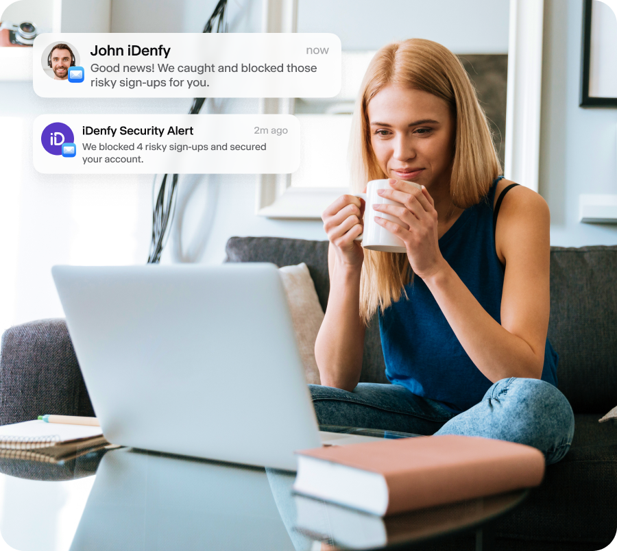 A woman sitting by her computer, checking iDenfy security alerts.